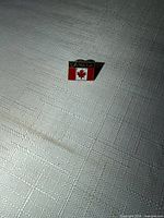 Front view of enamel Canada flag lapel pin