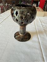Full view of ceramic chalice showing pierced diamond pattern and glaze