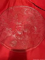 Top view of round crystal serving dish showing full festive relief pattern