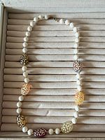 Full necklace laid flat showing bead sequence and clasp