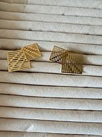 Front view of both earrings showing openwork square design