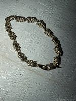 Full view of gold tone bracelet laid flat