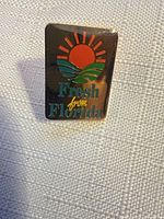 Front view of rectangular enamel lapel pin with Fresh from Florida logo