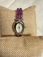 Front view of Imaginations watch on cushion