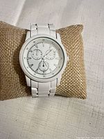 Front view of Merona wristwatch on display pillow