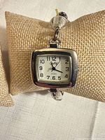 Front view of watch on cushion showing dial and case