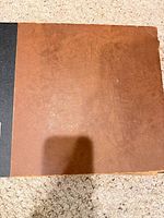 Front cover of brown and black record binder
