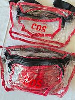 Both clear red-trimmed CDS fanny packs front view