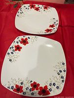 Two Gibson square dinner plates displaying floral pattern