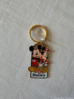 Front view of Mickey & Minnie Hailey keychain showing characters and name panel