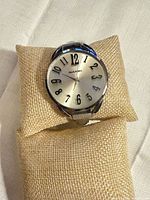 Front view showing dial, numerals, brand