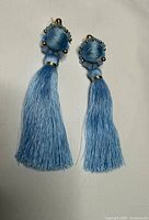 Front view showing full length of both blue tassel earrings