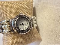 Front view of watch on cushion