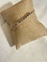 Full view of bracelet on display pillow