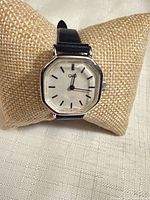 Front view of Q&Q watch on cushion displaying dial and case