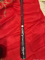 Full view of Rawlings Velo bat on red background