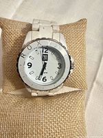 Front view of white Roxy analog watch on cushion showing dial details and bezel