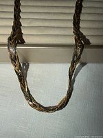 Close view of twisted strands showing tri-color metal tones