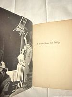 Book open showing production photograph and half-title page