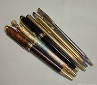 Group shot of eight vintage pens showing finishes and sizes