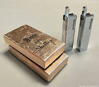 Two Noble lighters standing beside their boxes