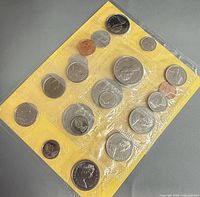 Front view of mixed-year coin set in sealed cellophane showing both sides of coins