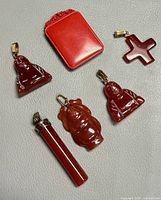 All six pendants laid out on grey surface