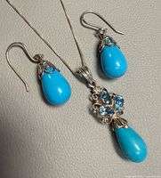 Necklace pendant and both earrings close-up