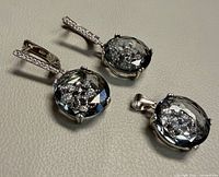 Close view of pendant and earrings showing crystal design and sterling settings