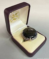Ring in presentation box showing gemstone and bezel