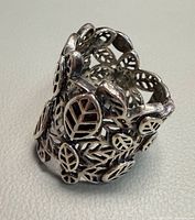 Perspective view of wide filigree leaf sterling ring