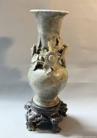 full front view of carved soapstone vase on stand