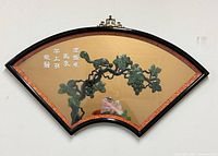Front view of fan-shaped jade wall art in frame