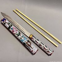 Knife, sheath, and chopsticks displayed