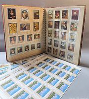 album open showing Ras Al Khaimah art stamps and loose Mongolian sheet