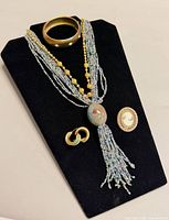 All items arranged: necklace, bracelet, earrings, brooch