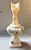 Front view of carved alabaster urn ewer on square base