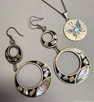 Necklace and earrings laid out showing overall design and abalone inlay