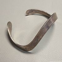Oblique view of full cuff showing curved modernist design