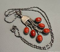 Pendant with chain laid flat showing stones and clasp