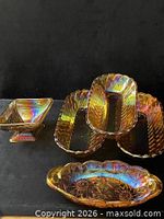 Group shot of five carnival glass pieces showing compote and four dishes