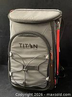 Front view showing branding, bungee cord, orange zipper pull