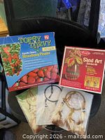 Boxed Topsy Turvy planter, boxed Avalon sand art kit, three dreamcatcher kits on chair