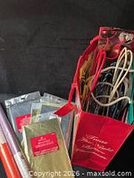 red carrier bag containing assorted gift bags, tissue packs and wrap rolls