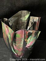 Front view showing iridescent highlights and folded rim