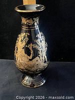 Full view of black ceramic vase showing gold Greek figure design