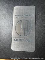 Front view of brushed metal VIP pass showing all etched details