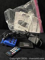 All components including controller, remote, hub, power adapter, manuals