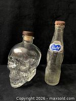 Glass skull decanter beside Bireley’s bottle