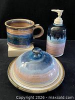 Front view of mug, dispenser, lidded plate assembled